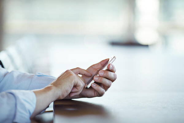 Working Art Print featuring the photograph Close-up Of Hands Scrolling On Phone by Klaus Vedfelt