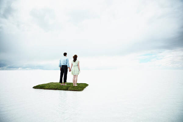 Young Men Art Print featuring the photograph Couple On Small Island In Large Body Of by Thomas Barwick