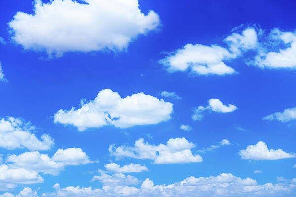 Tranquility Art Print featuring the photograph Fluffy White Clouds In A Blue Sky by Emrah Turudu