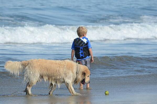 Young Boy And Dog On Beach Art Print featuring the photograph Lost In The Moment by Fraida Gutovich