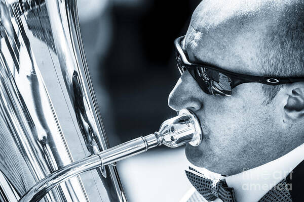 Brass Art Print featuring the photograph Male In Sunglasses Blowing Mouthpiece Of Tuba by Peter Noyce