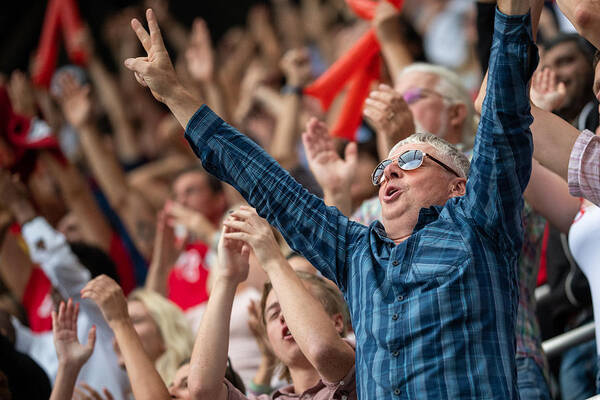 Event Art Print featuring the photograph Man with arms raised in a stadium crowd by Vm