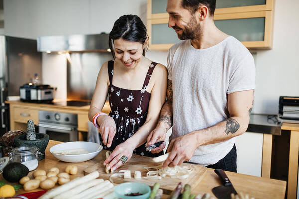 Heterosexual Couple Art Print featuring the photograph Mature couple preparing food for dinner by Hinterhaus Productions