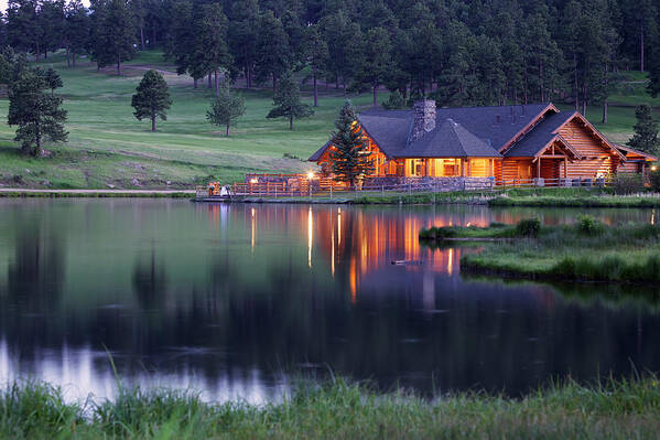 Water's Edge Art Print featuring the photograph Mountain Lodge Reflecting In Lake At by Beklaus