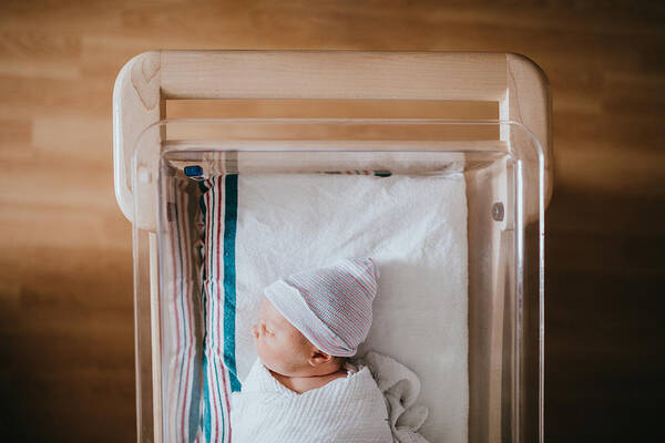 People Art Print featuring the photograph Newborn Baby Sleeping In Hospital Bassinet by RyanJLane