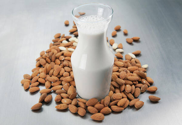 Almond Milk Art Print featuring the photograph Pitcher Of Milk And Raw Almonds by Laurie Castelli