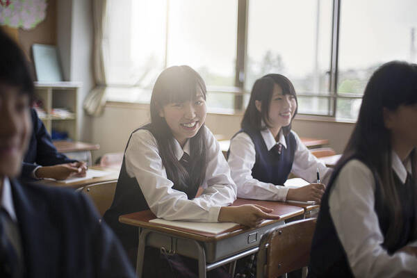 Expertise Art Print featuring the photograph Portrait of happy high school girls in classroom by Xavier Arnau