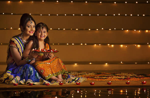 Hinduism Art Print featuring the photograph Portrait of mother and daughter with tray of diyas by Hemant Mehta