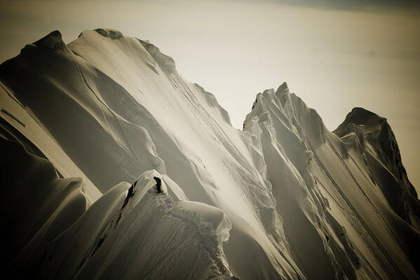 25-29 Years Art Print featuring the photograph Skier Standing On Snowy Mountain Ridge by Adam Clark