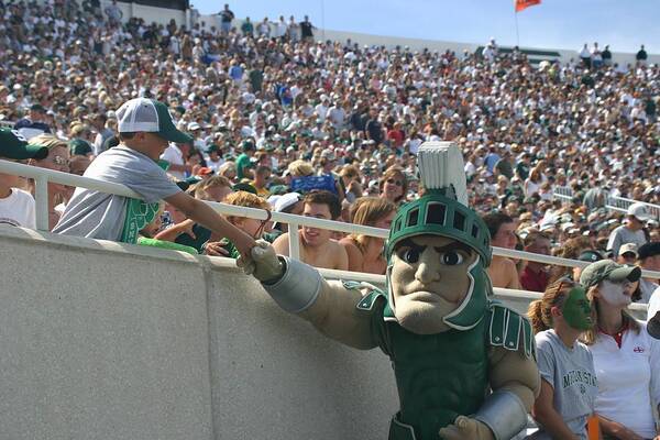 Michigan State University Art Print featuring the photograph Sparty at a football game with kid by John McGraw