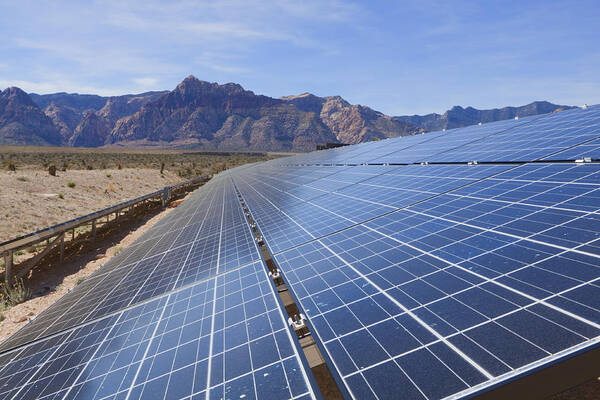 Scenics Art Print featuring the photograph Tilted solar panels, near the mountains of the Mojave Desert by Andreiorlov