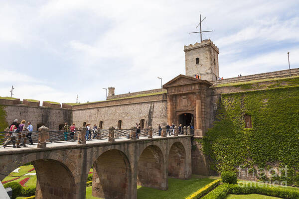 Barcelona Art Print featuring the photograph Visitors entering over bridge Montjuic Castle in Barcelona by Peter Noyce