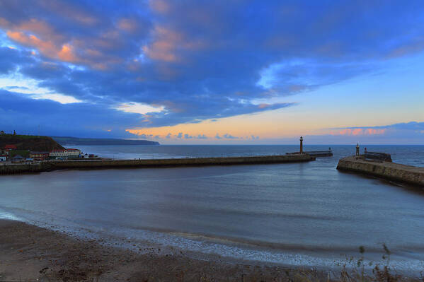 Water's Edge Art Print featuring the photograph Whitby Harbour Entrance At Sunset by Louise Heusinkveld