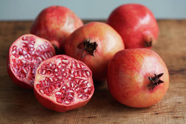 Cutting Board Art Print featuring the photograph Whole And Halved Pomegranates by Danielle Wood