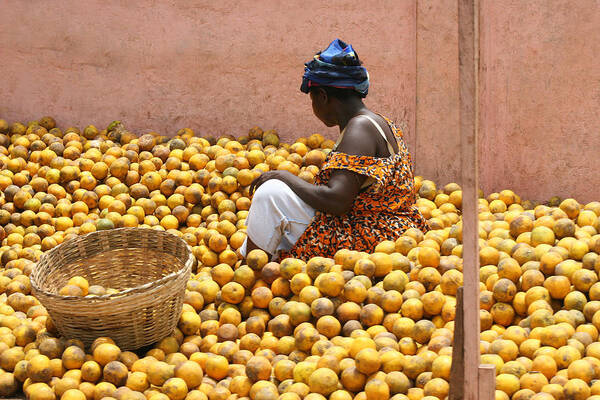 Three Quarter Length Art Print featuring the photograph Woman selling oranges at market in Ghana by Nisa and Ulli Maier Photography