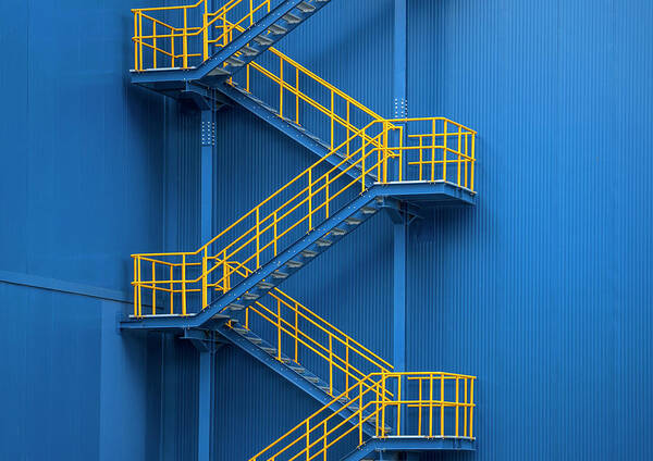 Tranquility Art Print featuring the photograph Yellow Metal Staircase Against A Blue by Ozgur Donmaz