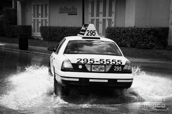 Street Art Print featuring the photograph Yellow Taxi Cab Driving Through Streets Flooded By Heavy Rainfall Key West Florida Usa by Joe Fox
