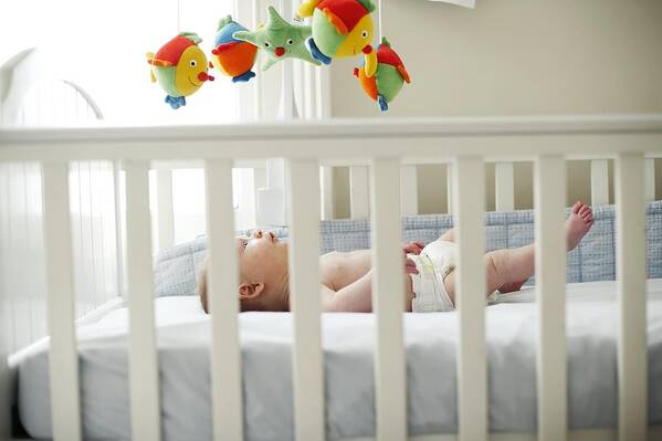 12-17 Months Art Print featuring the photograph Baby Boy In His Cot #1 by Ian Boddy