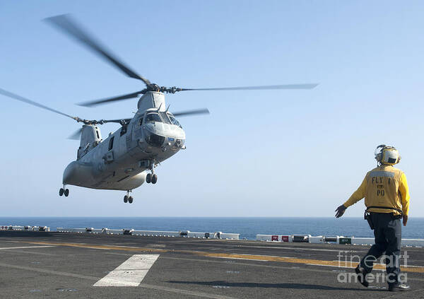 Uss Makin Island Art Print featuring the photograph A Ch-46e Sea Knight Helicopter Prepares #2 by Stocktrek Images