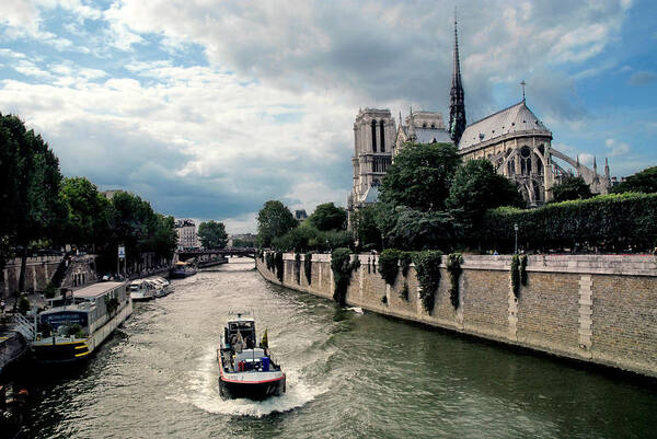 Notre Dame Art Print featuring the photograph Tour Boat Passing Notre Dame by Dave Mills