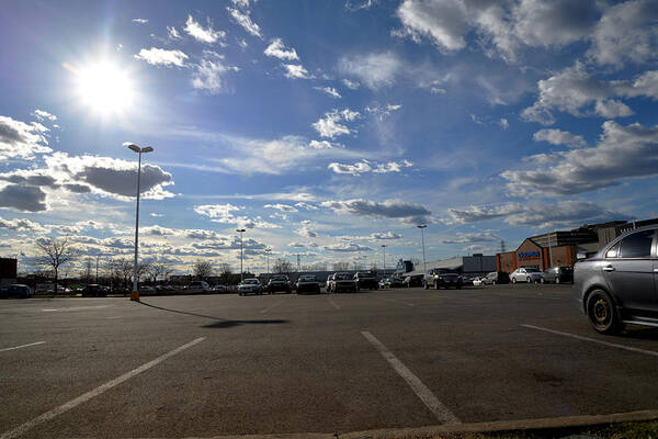 Parking Art Print featuring the photograph Clouds And Parking Lot by Jean-Marc Robert