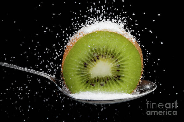 Kiwi Art Print featuring the photograph Kiwi fruit cut in half on a spoon with sugar by Simon Bratt