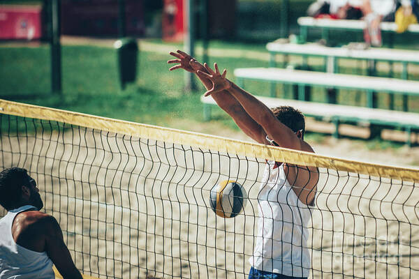 Beach Volleyball Art Print featuring the photograph Beach Volleyball Players At The Net #1 by Microgen Images/science Photo Library