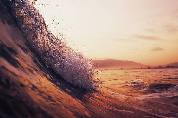 Scenics Art Print featuring the photograph A Large Wave In The Ocean At Sunset by Ben Welsh / Design Pics