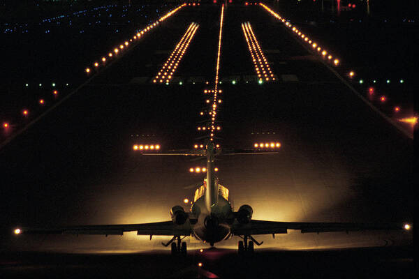 Taking Off Art Print featuring the photograph Airplane On Runway At Night by Comstock