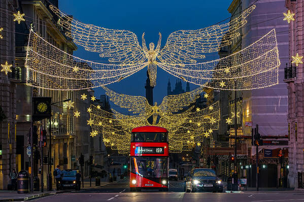 London Art Print featuring the photograph A double decker bus seen in London, during Christmas, at Piccadilly Circus. by George Afostovremea