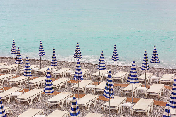 Beach Umbrellas In Nice Art Print featuring the photograph Beach Umbrellas in Nice by Melanie Alexandra Price