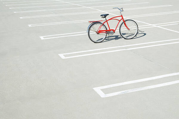 Out Of Context Art Print featuring the photograph Bike In Empty Parking Lot by Peter Starman