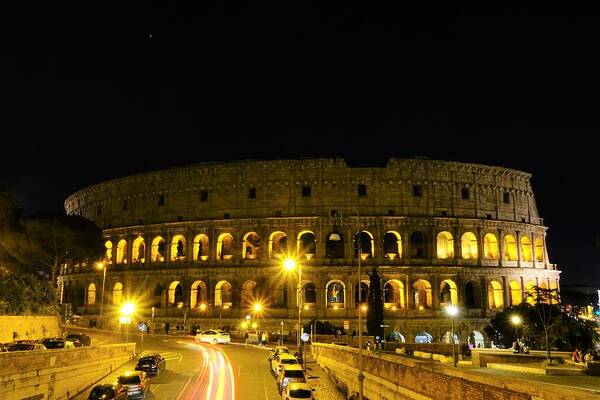 Colosseum At Night Art Print featuring the photograph Cars speeding by the Colosseum at night by Patricia Caron