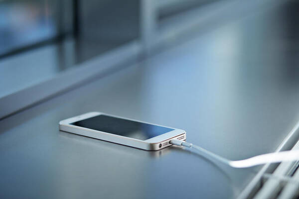 Office Art Print featuring the photograph Close-up Of Smartphone Charging by Klaus Vedfelt