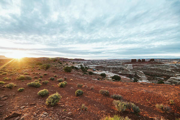 National Park Art Print featuring the photograph Golden Light Of Sunrise Over Camp At The Edge Of The Maze In Utah by Cavan Images