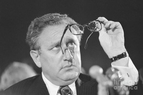 Senate Appropriations Committee Art Print featuring the photograph Henry Kissinger Looking At Glasses by Bettmann