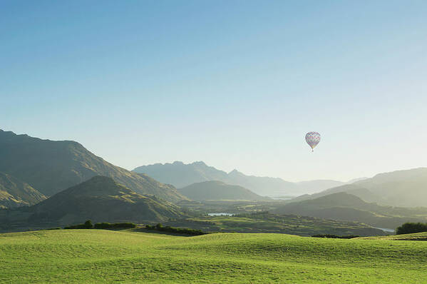 Tranquility Art Print featuring the photograph Hot Air Balloon Flying Above Rolling by Jacobs Stock Photography Ltd