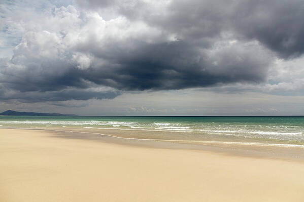 Water's Edge Art Print featuring the photograph Low Storm Clouds Over Jandía Beach by Julio Lopez Saguar