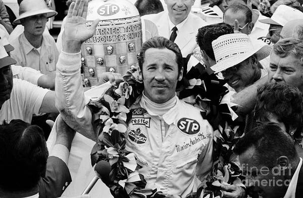 Hand Raised Art Print featuring the photograph Mario Andretti Bedecked With Flowers by Bettmann