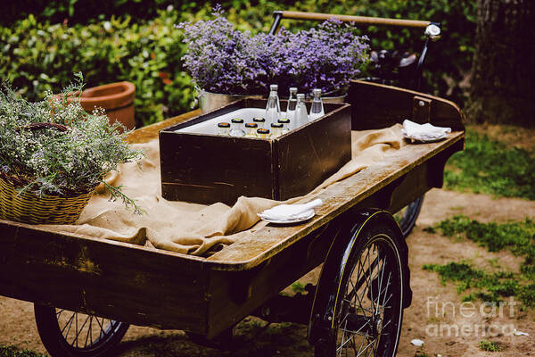 Aged Art Print featuring the photograph Old wooden cart to transport goods used for decoration at a wedding. by Joaquin Corbalan