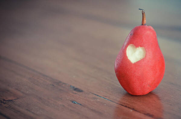 Wood Art Print featuring the photograph Red Pear With Heart Shape Bit by Danielle Donders