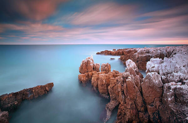 Scenics Art Print featuring the photograph Rocks In Sea At Sunset by Eric Rousset