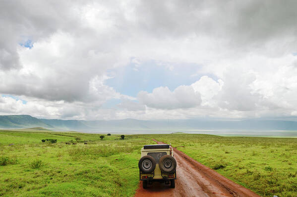 Grass Art Print featuring the photograph Safari Vehicle W Tourists In Ngorongoro by Volanthevist