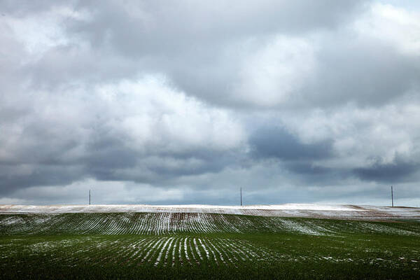 Snow Art Print featuring the photograph Snow Dusted Field With Storm Coulds by Nivek Neslo