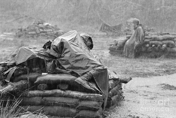 Following Art Print featuring the photograph Soldier Sleeping During Downpour by Bettmann