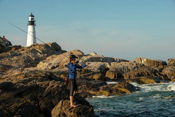Coast Of Maine Art Print featuring the photograph Woman Fly Fishing Near Portland Headlight In Maine by Cavan Images