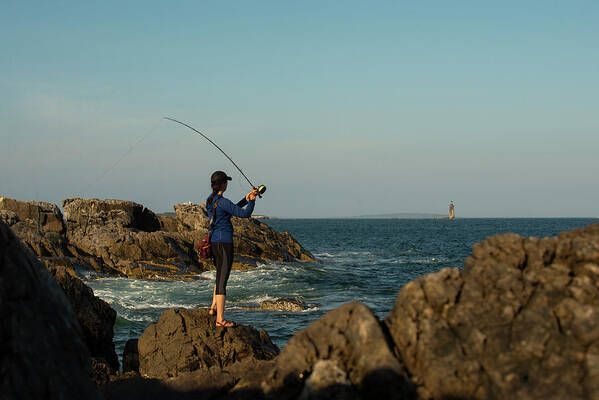 Fly Fishing Art Print featuring the photograph Woman Fly Fishing On The Coast Of Maine On A Sunny Day. by Cavan Images