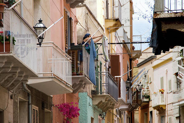 Tranquility Art Print featuring the photograph Woman Stretches Out The Clothes To Dry by Aldo Pavan