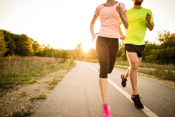 Young Men Art Print featuring the photograph Friends jogging at sunset #1 by Martin Novak