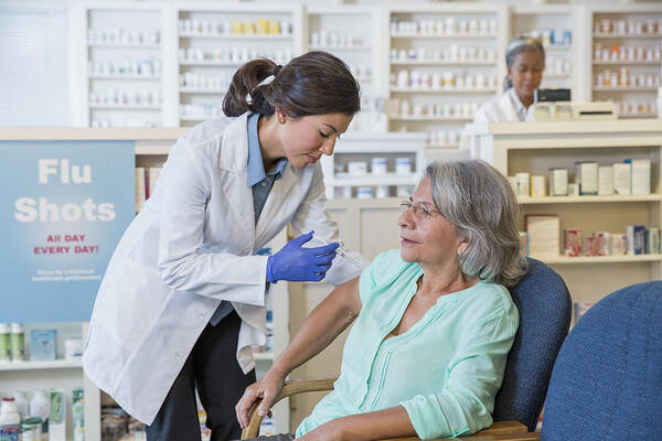 Expertise Art Print featuring the photograph Pharmacist giving customer flu shot #2 by Terry Vine